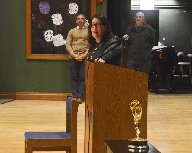 Ms Dowd speaking to assemby with the Emmy in the foreground