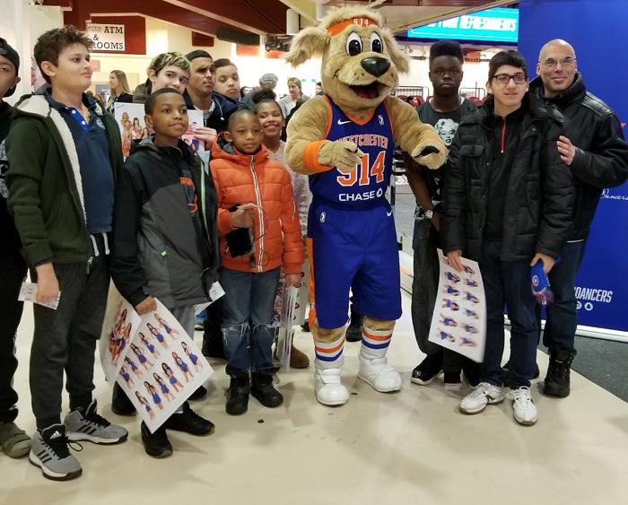 Students and staff standing next to the Knicks mascot