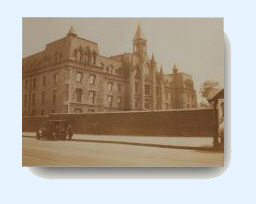 Early 20 century photo of the 9th Avenue school with model T automobile on street