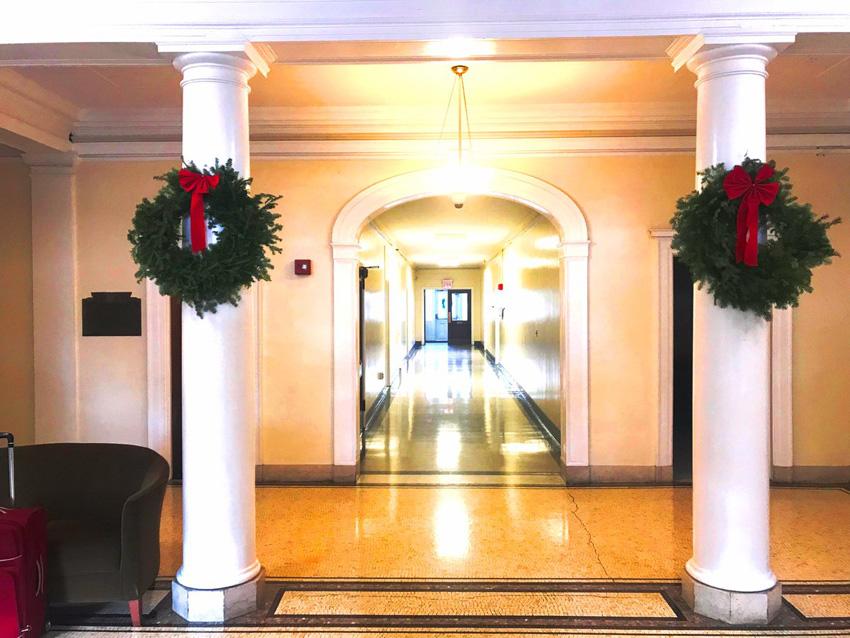 Insdie lobby of Schermerhorn hall with 2 wreaths on the columns