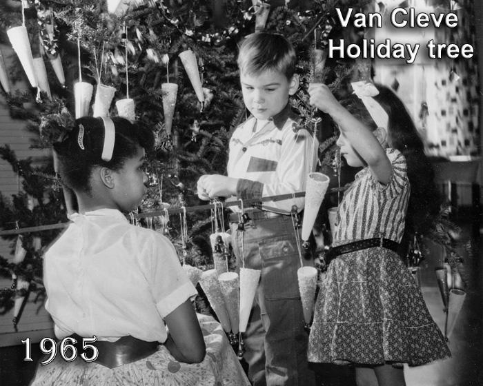 1965 Young children decorating a Christmas Tree