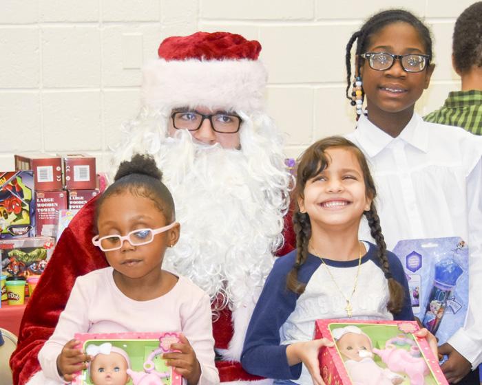 Schermerhorn students with their presents and Santa Claus