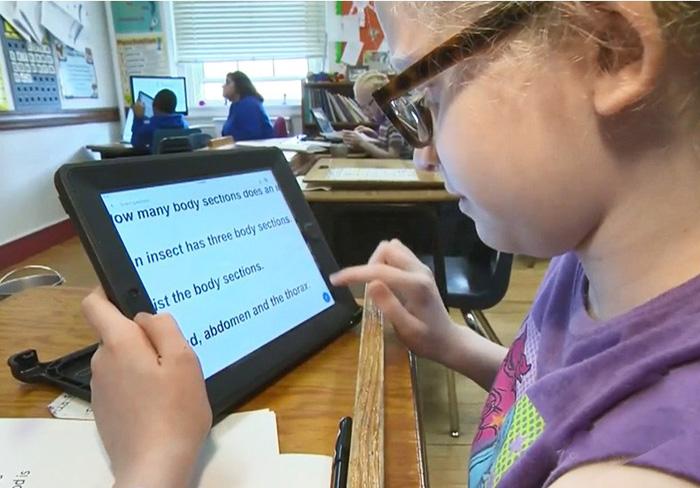 Low vision student using her iPad adapted for her vision loss