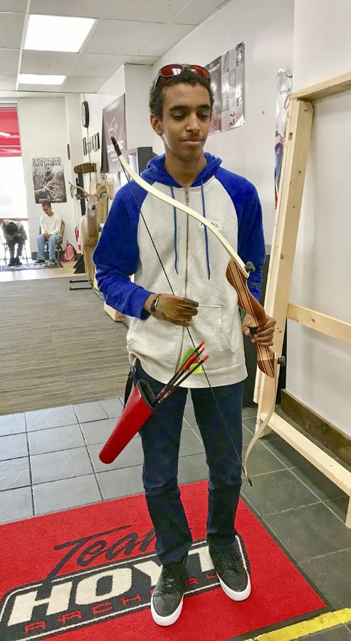 Image of student dressed with bow, quiver and glove. 