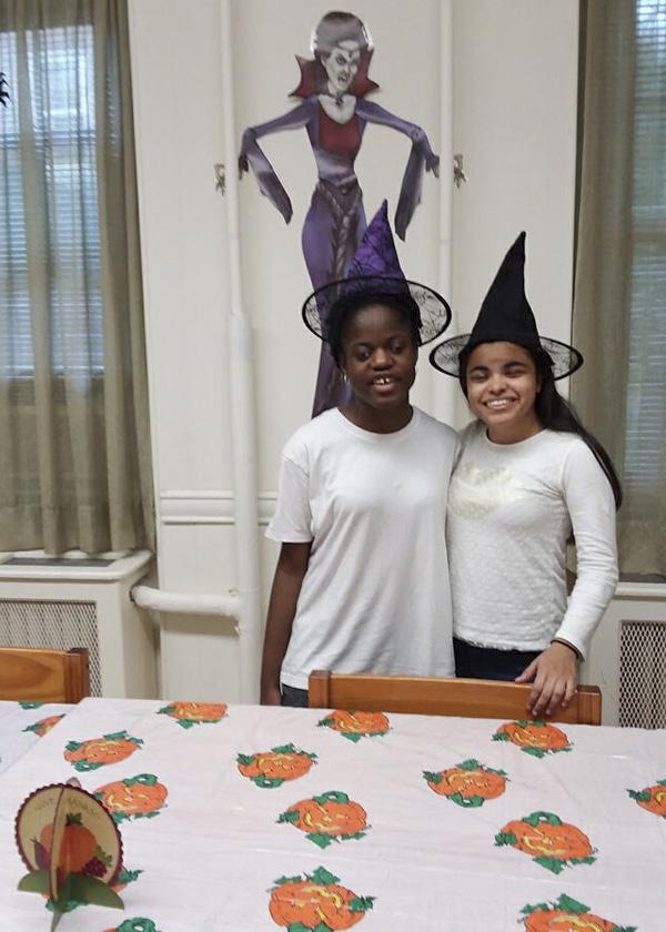 Resident "witches" Georgette and Natalie pose with for the camera while wearing witch hats
