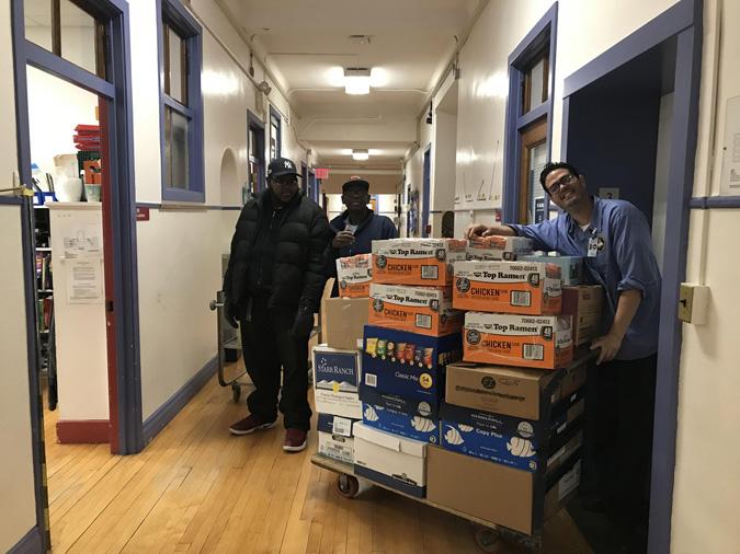 School porters loading boxes of donations to the elevator