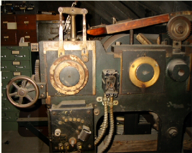 Side view of the printer showing a junction box and electrical switches.
