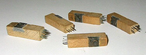 Closeup of 5 pin blocks showing the copper symbols