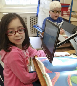 Young student reading with a CCTV